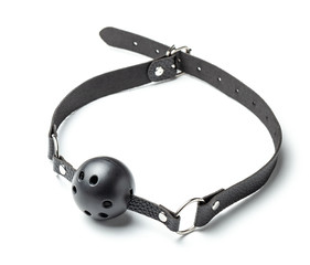 Ball gag in mouth isolated on white background. Intimate toys. Sex abuse slavery