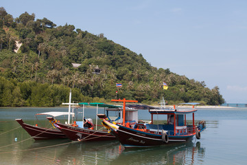 Fototapeta na wymiar Colorful boats with flags on Koh Samui. Transport on island.