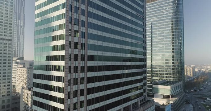 Drone footage of a movement between skyscrapers and glass office buildings in Warsaw.
