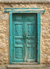 An old wooden traditional petrol green door in Galaxidi Greece