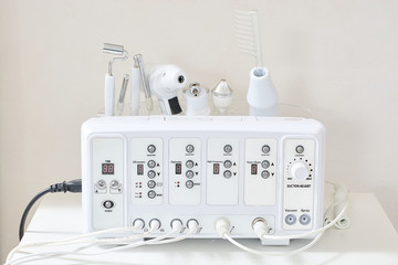 Cosmetic Multifunctional Device close-up in beauty salon. Ultrasound medical device. Darsonval device. Ultrasound procedure. Medical equipment healthcare. Young skin. Face professional massage.