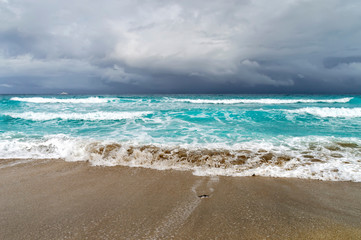 coast of the Atlantic Ocean during a storm, a white motor yacht on the horizon,