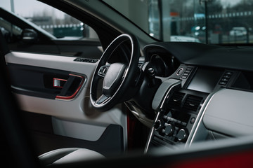 Obraz na płótnie Canvas buttons near black steering wheel in luxury car