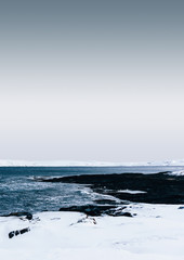 view of the Arctic Ocean from the shore in winter during a hard frost after a snowfall