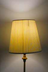 Old retro lamp shines in a classic interior. Old lampshade shines through a beautiful light