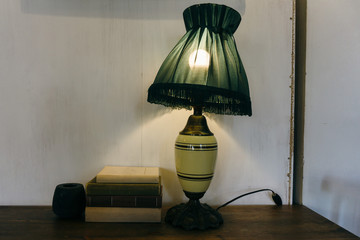 Old retro lamp shines in a classic interior. Old lampshade shines through a beautiful light
