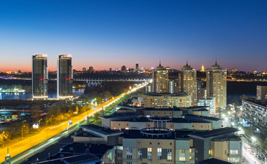 Fototapeta na wymiar aerial view to night capital of Ukraine with road traffic and night lights