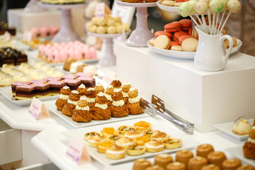 Delicious candy bar with cake pops, cupcakes, macaroons and other sweets