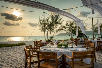 romantic wedding table design at sunset outside on asian beach