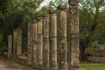 ancient Greece stone building from antique city in park outdoor space south European part of world in Peloponnese peninsula, soft focus pillars objects alley way