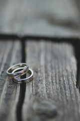 wedding rings on wooden background