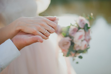 bride holds the groom's hand
