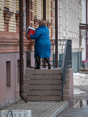 Urban streets. A woman delivery the documents from government