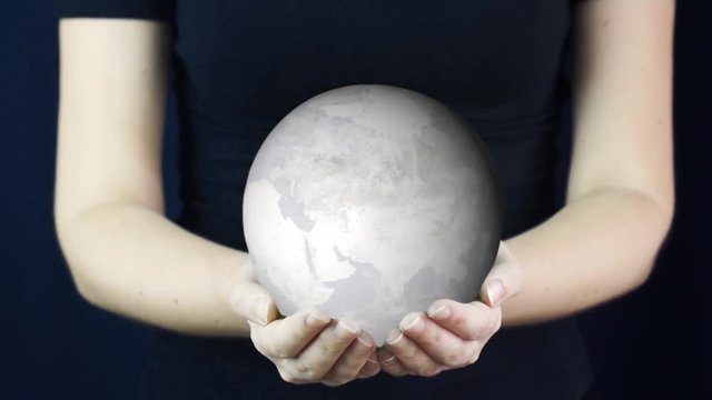 Young woman hold Earth is covered with ice and snow. Ice ageю Element of this video furnished by NASA