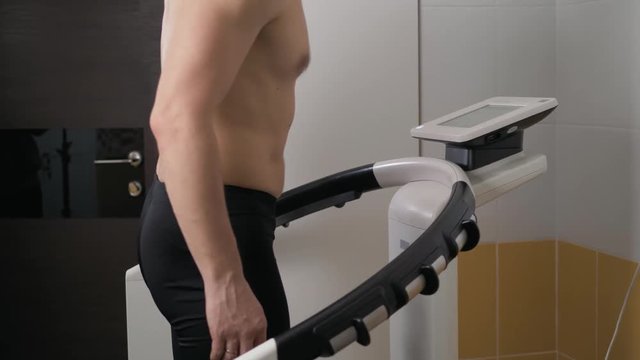 orthopedic physiotherapist check body growth of young athlete sport man body mass analysis weight control