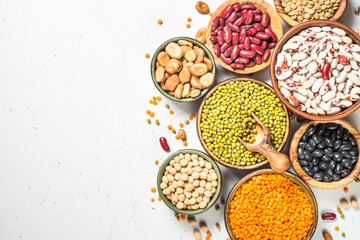 Legumes, lentils, chikpea and beans assortment on white.