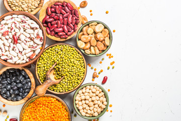 Legumes, lentils, chikpea and beans assortment on white.