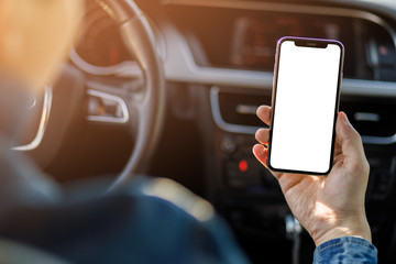 Young business man with phone in car. Man holding smartphone with screen .