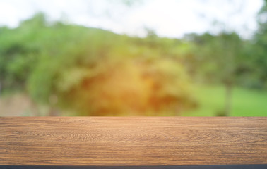 Empty dark wooden table in front of abstract blurred bokeh background of restaurant . can be used for display or montage your products.Mock up for space.