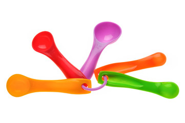 multicolored plastic measuring spoons in grams