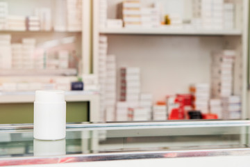 Medicine box standing on the shelf, there are medicine cabinets in the background