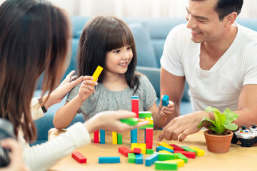 happy family caucasian and asian mixed race with pretty daughter enjoy family time with toy  together living room home background