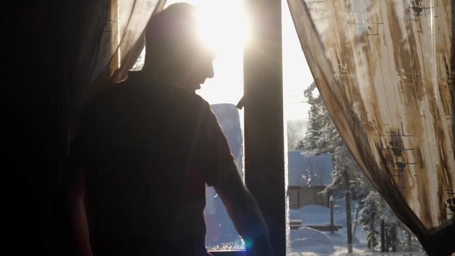 Young man enjoying view of mountain and forest in morning during sunrise. Rear back view. slow motion. 3840x2160