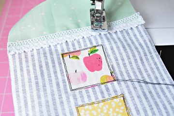 Sewing process: pieces of fabric, needle and thread