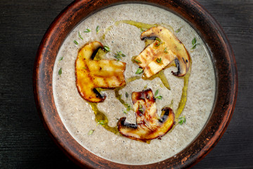 Cream soup with mushrooms champignon, dishes made of natural clay-2.