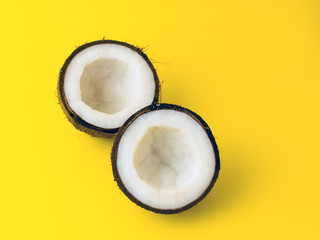 Coconut on yellow colored background, flat lay, top view