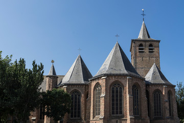 Fototapeta na wymiar Sint Antonius Abt Church in Blankenberge, Belgium. Blue sky, space for text