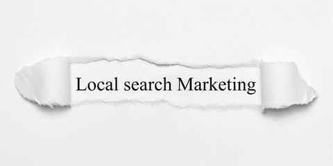Local search Marketing on white torn paper