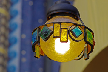 Suspended street lamp made of metal and colored glasses