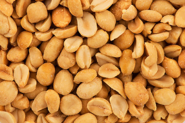 Close up on stack of salty peanuts as abstract background. Copy space for your text.