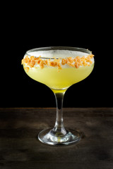 Cocktail with orange zest and whipped frothy.