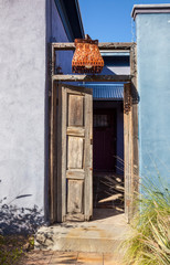 Fototapeta premium Weathered vintage Tucson, Arizona open door with rusty light fixture.