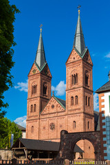 Obraz premium Perfect portrait view of the two Romanesque Revival towers at the west façade of the historic Basilika St. Marcellinus und Petrus, also known as Einhard-Basilika in Seligenstadt, Germany.