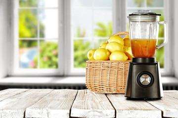 blender in kitchen with white wooden window and fresh lemon fruits 