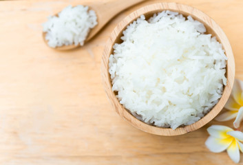 Obraz na płótnie Canvas Close up white rice in wooden bowl with spoon, healthy food, selective focus