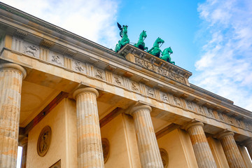 Brandenburg Gate Brandenburger Tor details in Berlin, Germany during bright day with a blue sky. Famous landmark in Berlin.