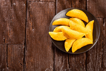 Delicious empanadas - Colombian cuisine. Wood background