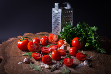 Red fresh tomatoes, grater, salt, bay leaf and parsley.