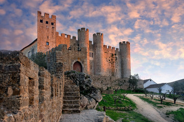 Castle in the city of Obidos Portugal at sunset - obrazy, fototapety, plakaty