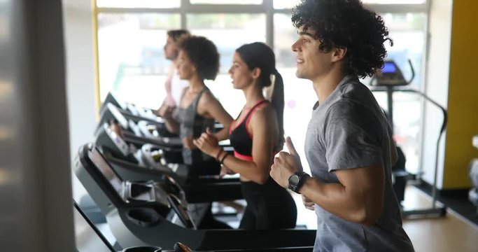 Picture of people running on treadmill in gym .