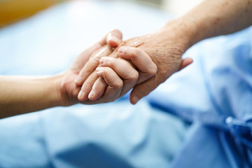 Holding Touching hands Asian senior or elderly old lady woman patient with love, care, helping, encourage and empathy at nursing hospital ward : healthy strong medical concept 