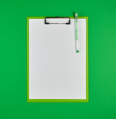 paper clipboard and pen on a green background