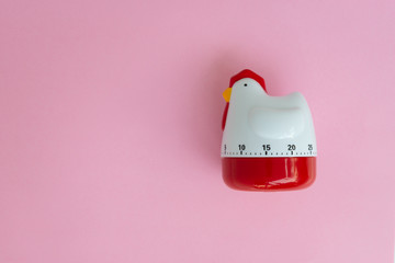 Cooking timer as chicken on the pink background
