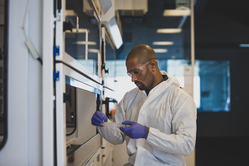 Scientist looking at sample in lab