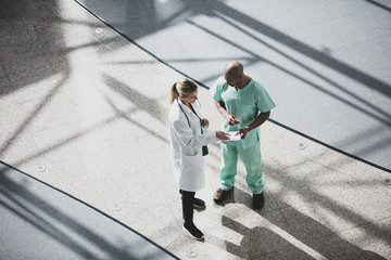 Overhead shot of medical professionals discussing results in a hospital