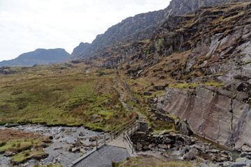 Wooden bridge on the Cwmorthin Waterfall trail in the mountains of Snowdonia National Park, Wales.